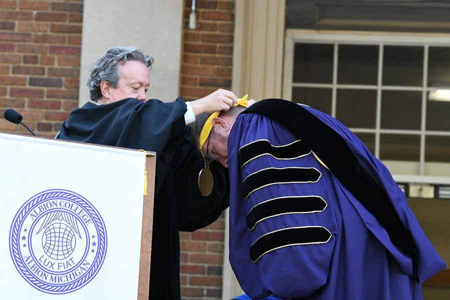 Michael Harrington places Presidential Medallion on Dr. Mathew Johnson at Albion College