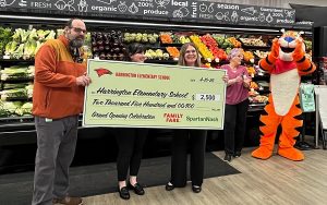 Harrington Elementary School Principal Beth Brownell accepts a $2,500 donation