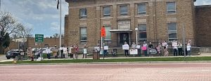 Demonstrators gathered on the sidewalk