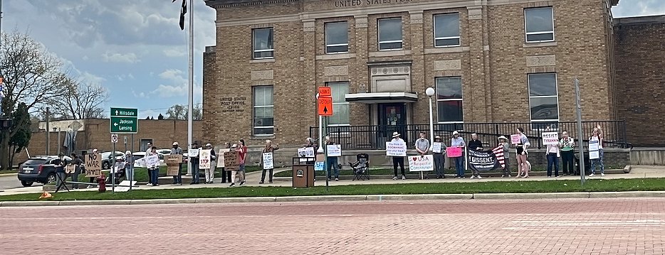 Demonstrators gathered on the sidewalk