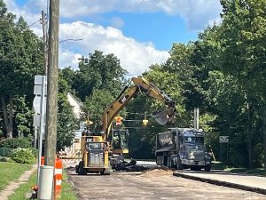 An excavator works along Austin Avenue