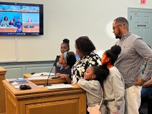 Harry Bonner Jr., right, parent coordinator at Harrington Elementary School, leads young participants